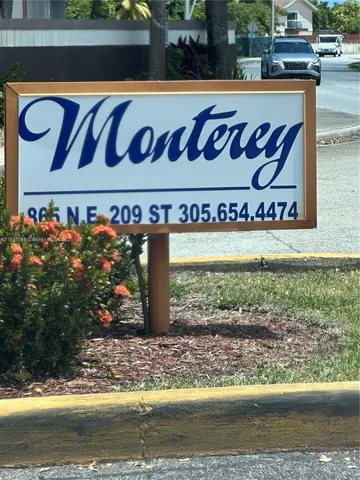 a street sign that is sitting on a wooden bench