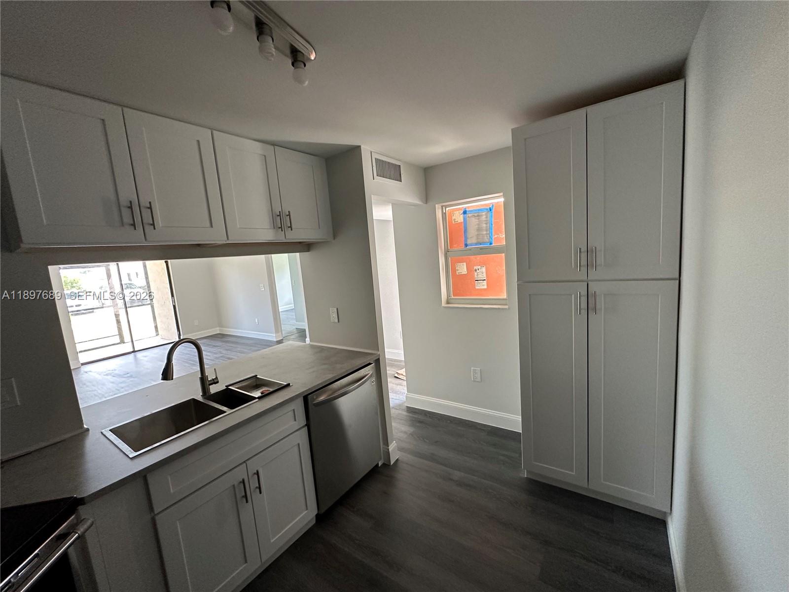 855 Northeast 209th Street, Unit 10334 Miami, FL 33179 - Photo 34 of 38 a kitchen with stainless steel appliances granite countertop a sink a stove and a refrigerator