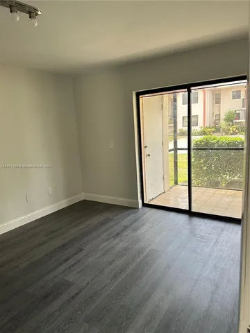 a view of a room with wooden floor and lake view