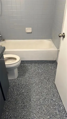 a bathroom with a toilet and a bathtub