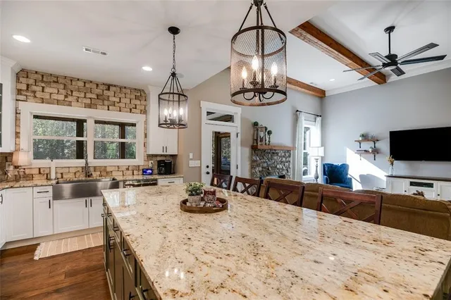 a kitchen with stainless steel appliances a stove a sink and a refrigerator