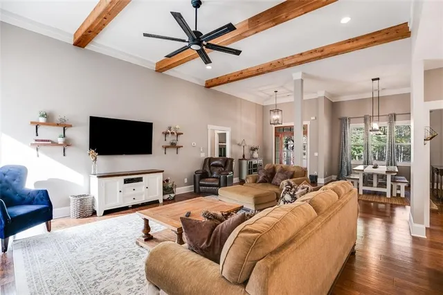 a view of a living room with furniture and floor to ceiling windows
