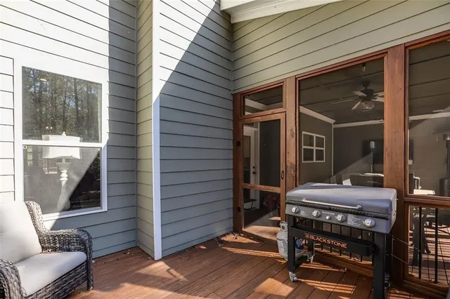 a bedroom with a bed and a flat tv screen on dresser