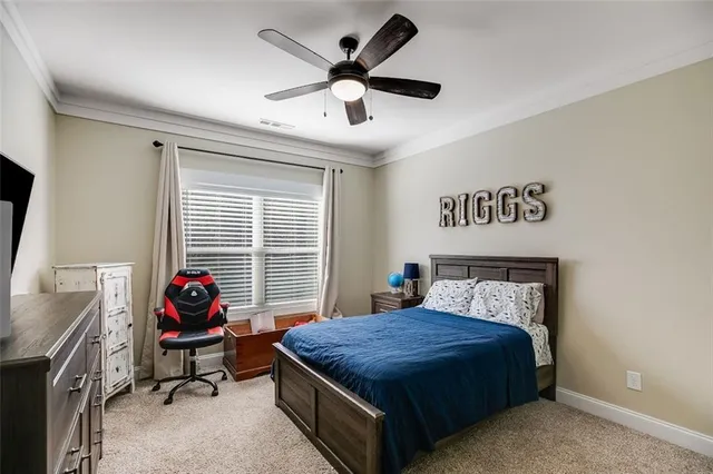 a bedroom with a bed and a flat tv screen on dresser