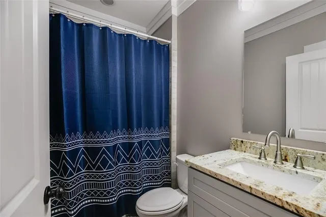a bathroom with a glass shower door and a sink