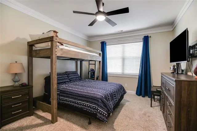 a bed sitting in a bedroom next to a window