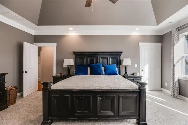 a spacious bedroom with a large bed and a flat screen tv