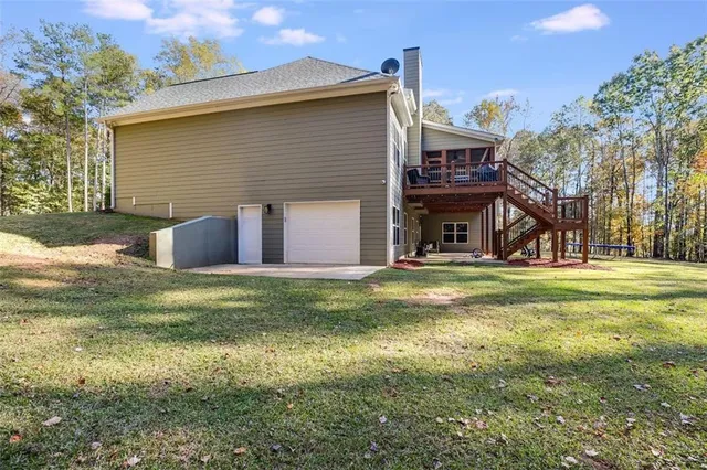a large kitchen with stainless steel appliances kitchen island wooden floors and view living room