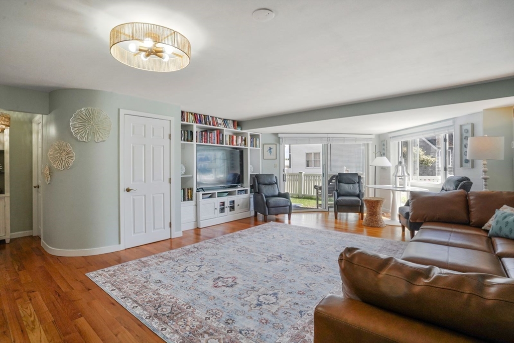 1 Commodore Court, Unit 104 Hull, MA 02045 - Photo 10 of 35 a living room with furniture and a flat screen tv