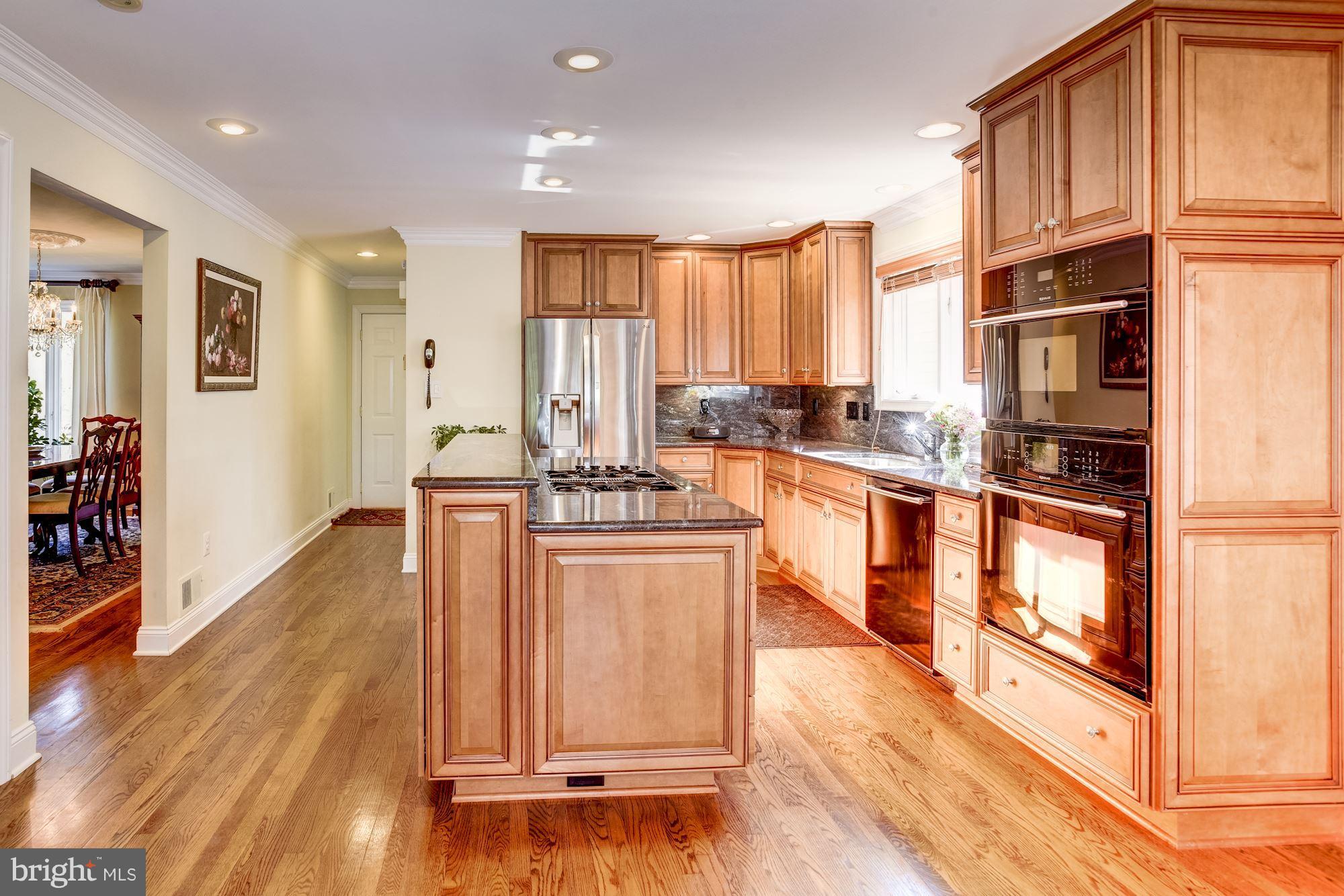 1300 Pavilion Club Way Reston, VA 20194 - Photo 9 of 30 a kitchen with stainless steel appliances granite countertop a refrigerator a stove top oven and a wooden floors