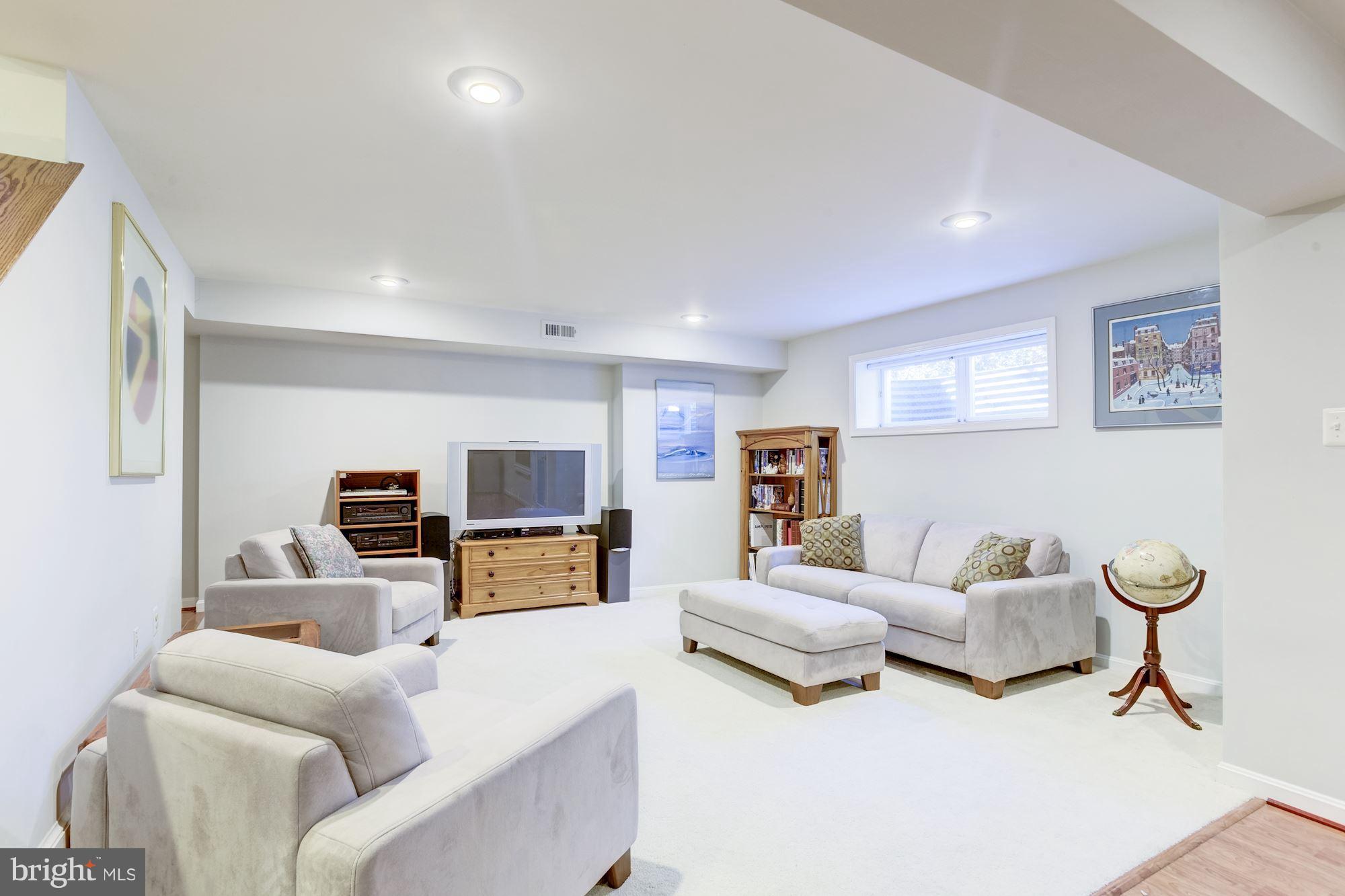 1300 Pavilion Club Way Reston, VA 20194 - Photo 22 of 30 a living room with furniture and a flat screen tv