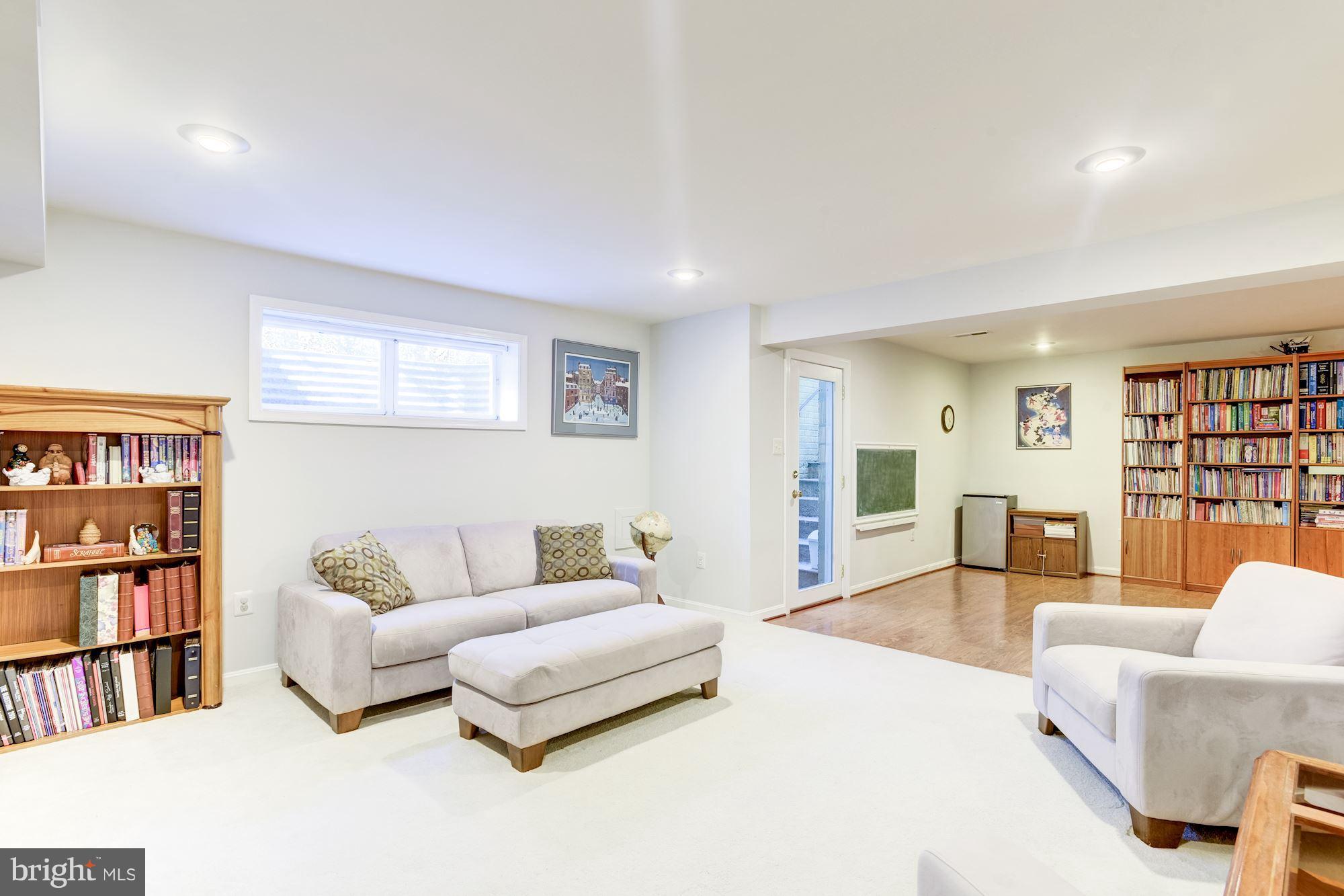 1300 Pavilion Club Way Reston, VA 20194 - Photo 23 of 30 a living room with furniture and a book shelf