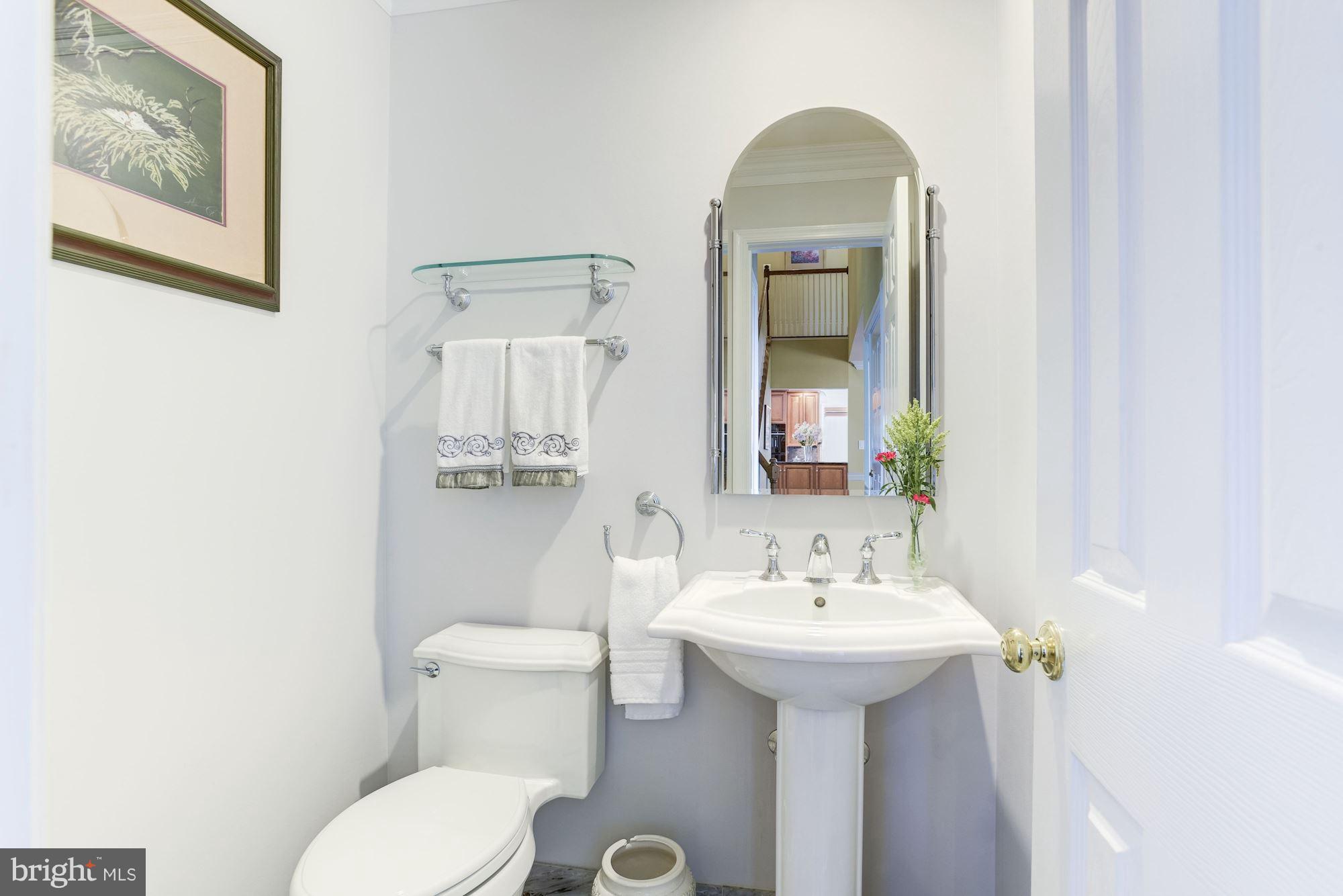 1300 Pavilion Club Way Reston, VA 20194 - Photo 5 of 30 a bathroom with a toilet sink and mirror