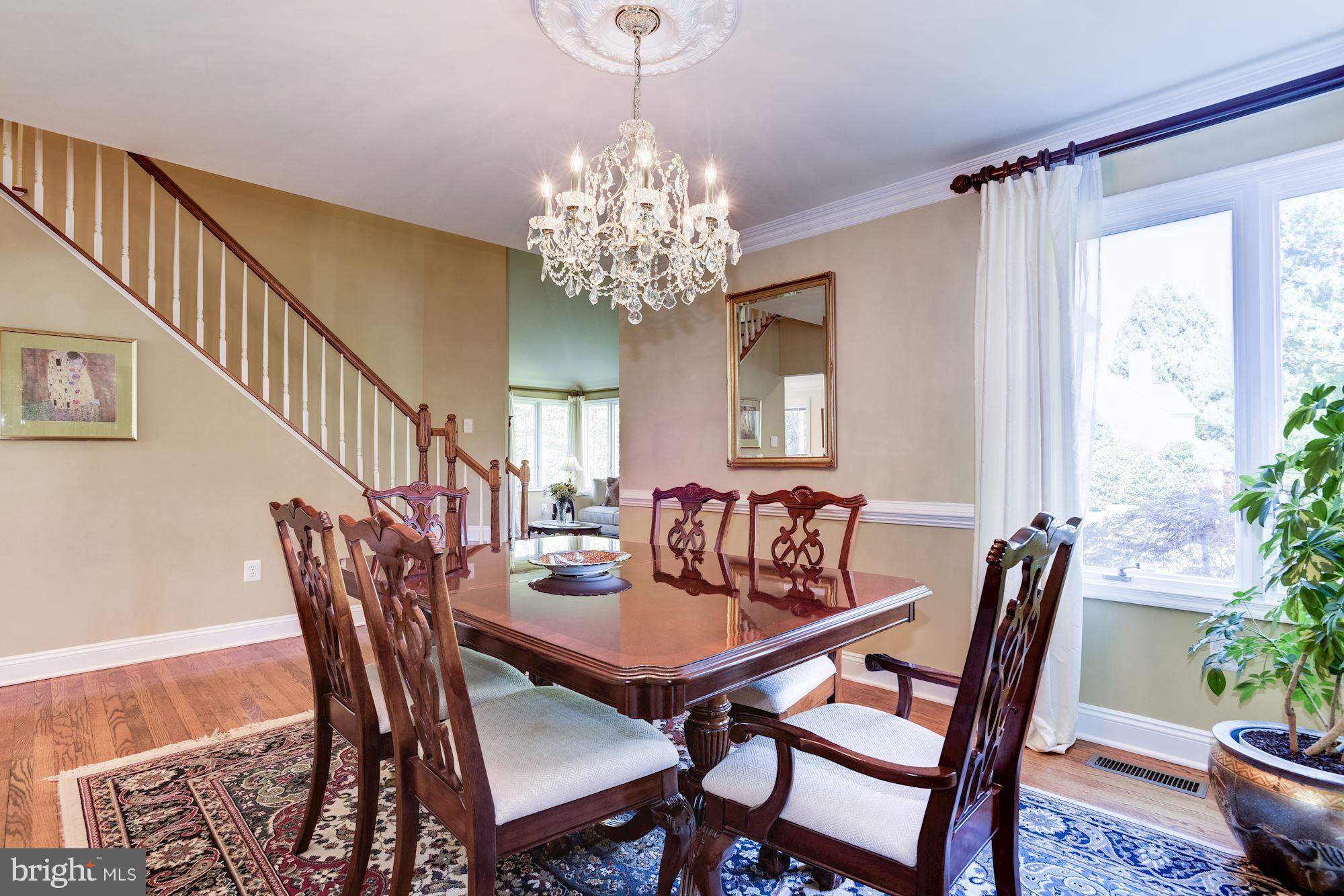 1300 Pavilion Club Way Reston, VA 20194 - Photo 29 of 30 a view of a dining room with furniture and a chandelier