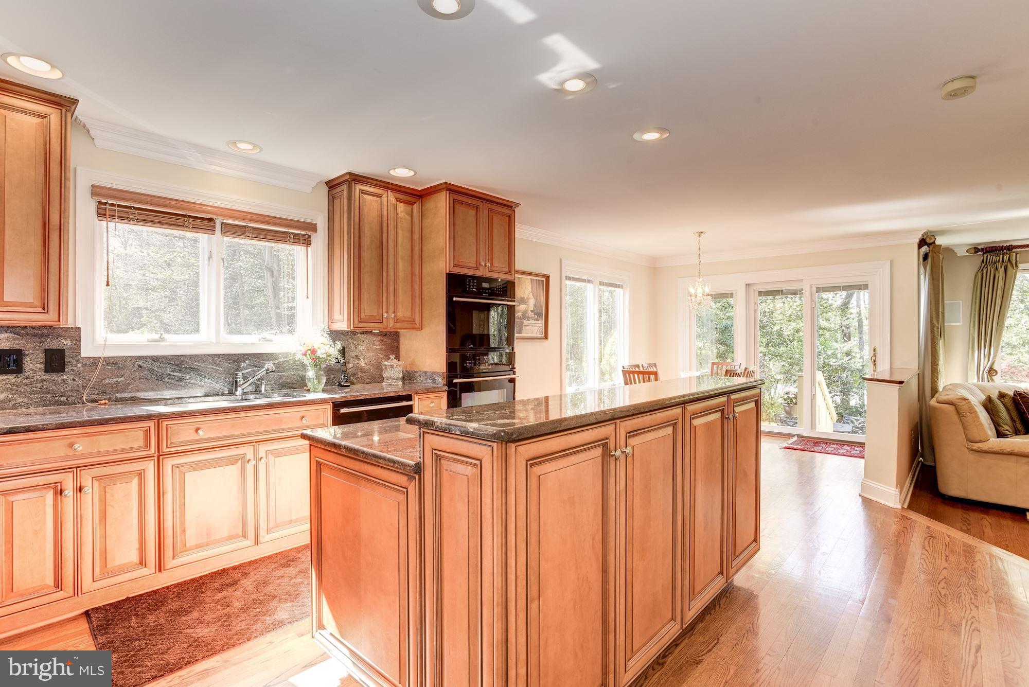 1300 Pavilion Club Way Reston, VA 20194 - Photo 7 of 30 a kitchen with stainless steel appliances granite countertop a refrigerator a sink dishwasher a stove and white countertops with wooden floor