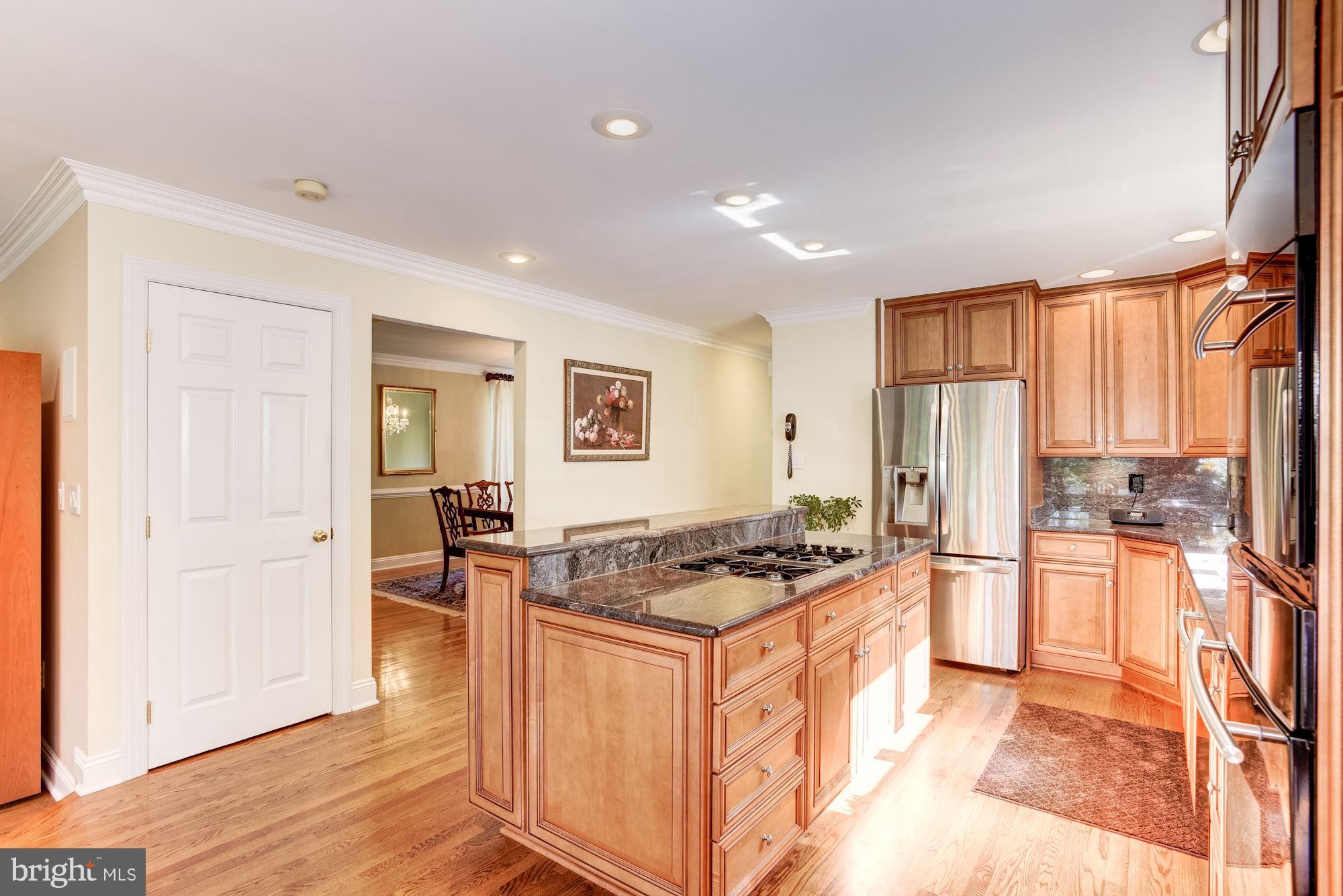 1300 Pavilion Club Way Reston, VA 20194 - Photo 8 of 30 a kitchen with stainless steel appliances granite countertop a stove top oven a sink and a refrigerator