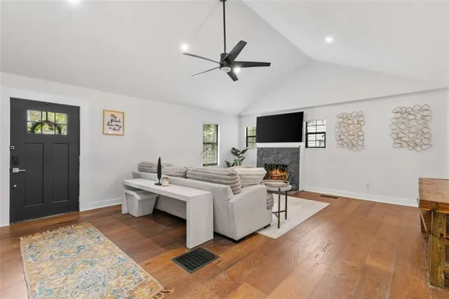 a living room with furniture a rug and a flat screen tv