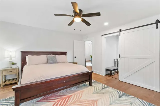 a bedroom with a bed and a ceiling fan