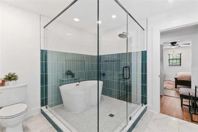 a bathroom with a shower a toilet and a sink