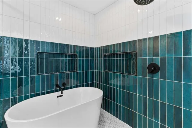 a bathroom with a shower and tub