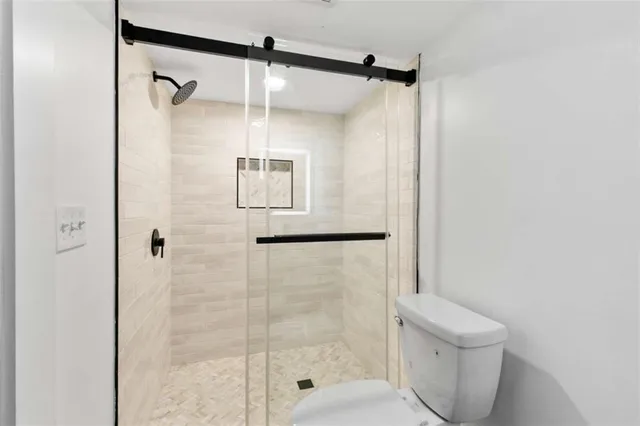 a bathroom with a shower and a toilet
