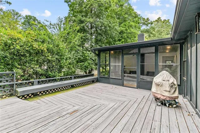 a view of balcony with wooden floor and seating space