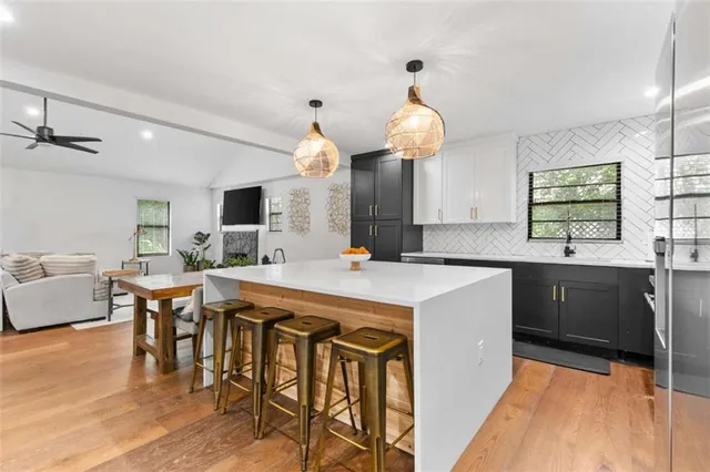 a large kitchen with a table and chairs