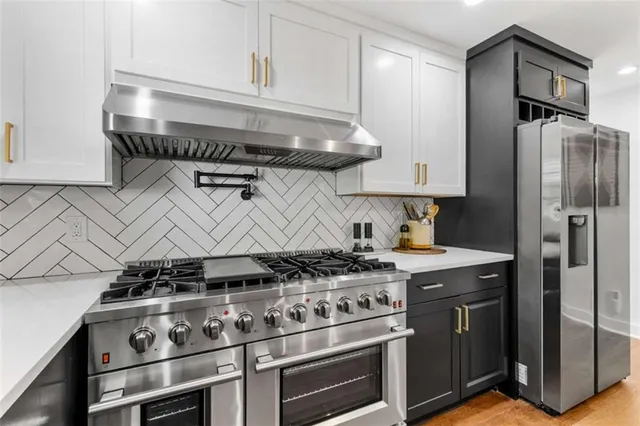 a stove top oven sitting inside of a kitchen