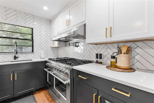 a kitchen with a stove and a sink