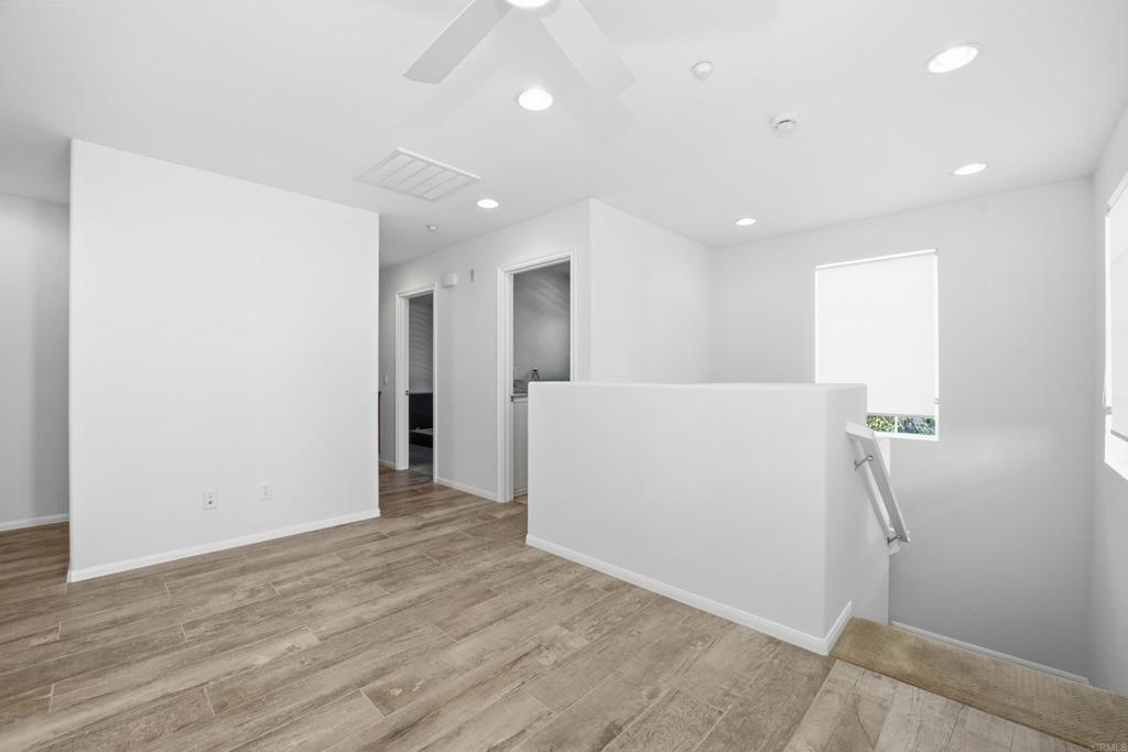 2284 Durango Way, Unit 200 San Marcos, CA 92078 - Photo 14 of 39 a view of a hallway with wooden floor