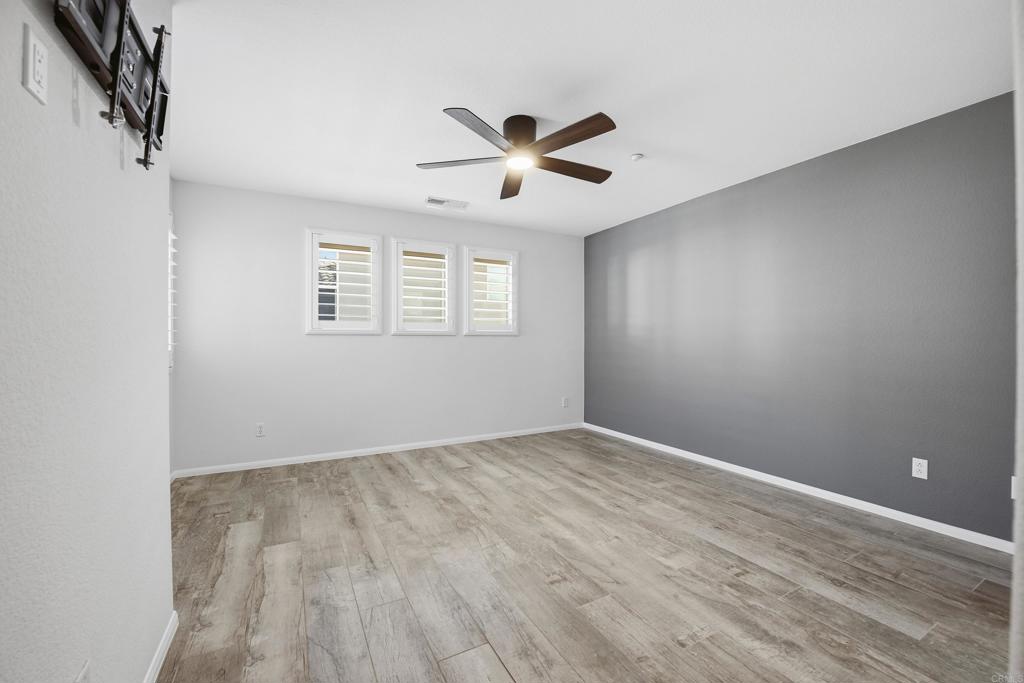 2284 Durango Way, Unit 200 San Marcos, CA 92078 - Photo 16 of 39 wooden floor in an empty room with a window