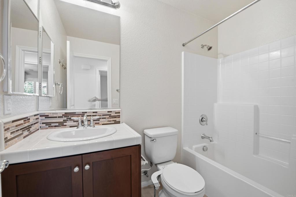 2284 Durango Way, Unit 200 San Marcos, CA 92078 - Photo 22 of 39 a bathroom with a sink toilet vanity and shower