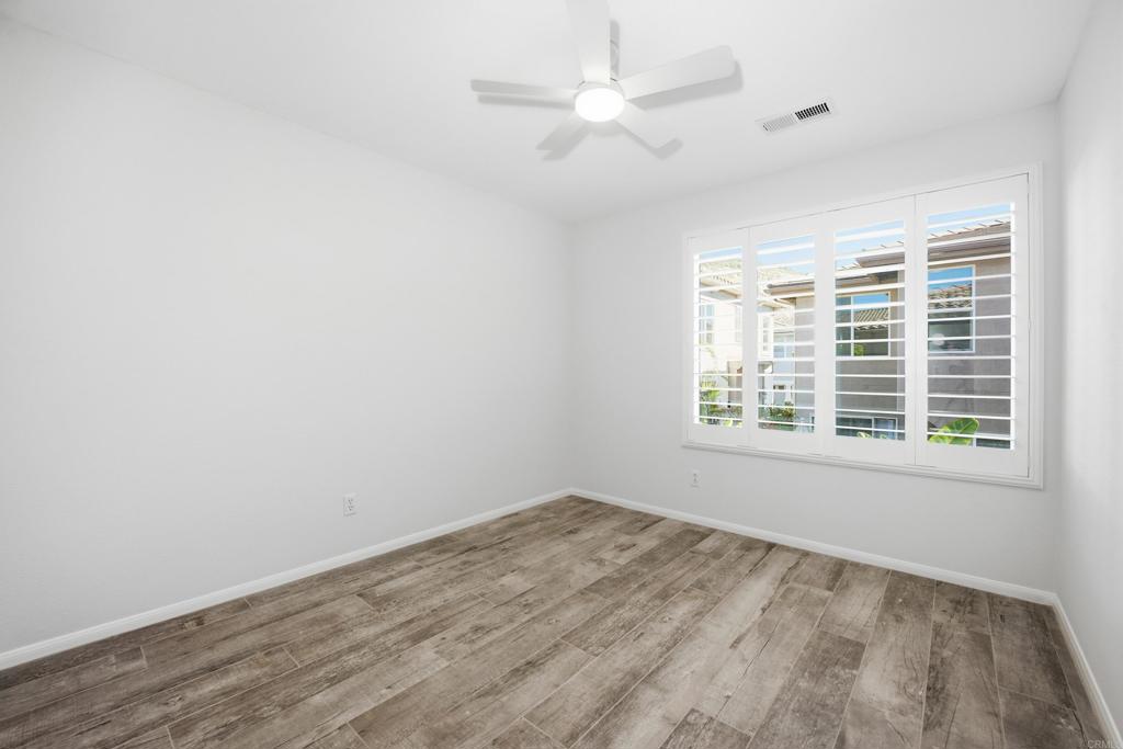 2284 Durango Way, Unit 200 San Marcos, CA 92078 - Photo 23 of 39 an empty room with a window and a fan