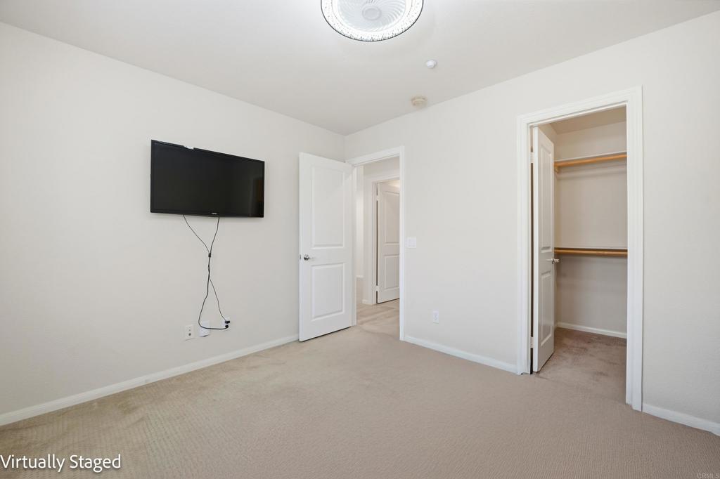 2284 Durango Way, Unit 200 San Marcos, CA 92078 - Photo 25 of 39 a living room with a flat screen tv and a white wall