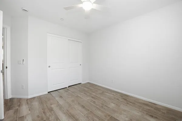 a bedroom with a large bed and a flat screen tv