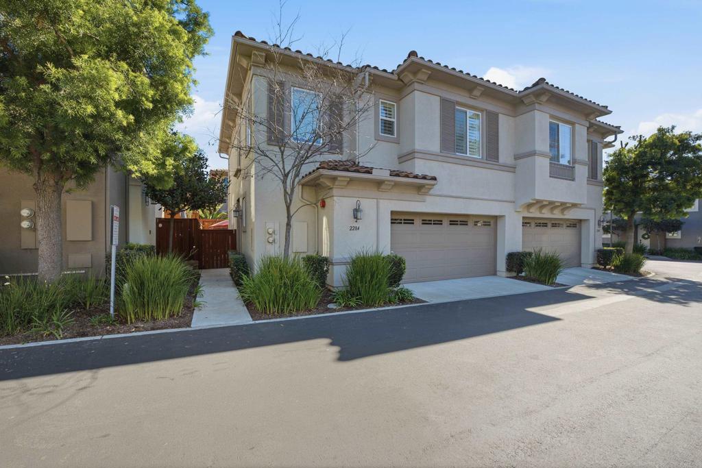 2284 Durango Way, Unit 200 San Marcos, CA 92078 - Photo 39 of 39 a front view of a house with a garden and a tree