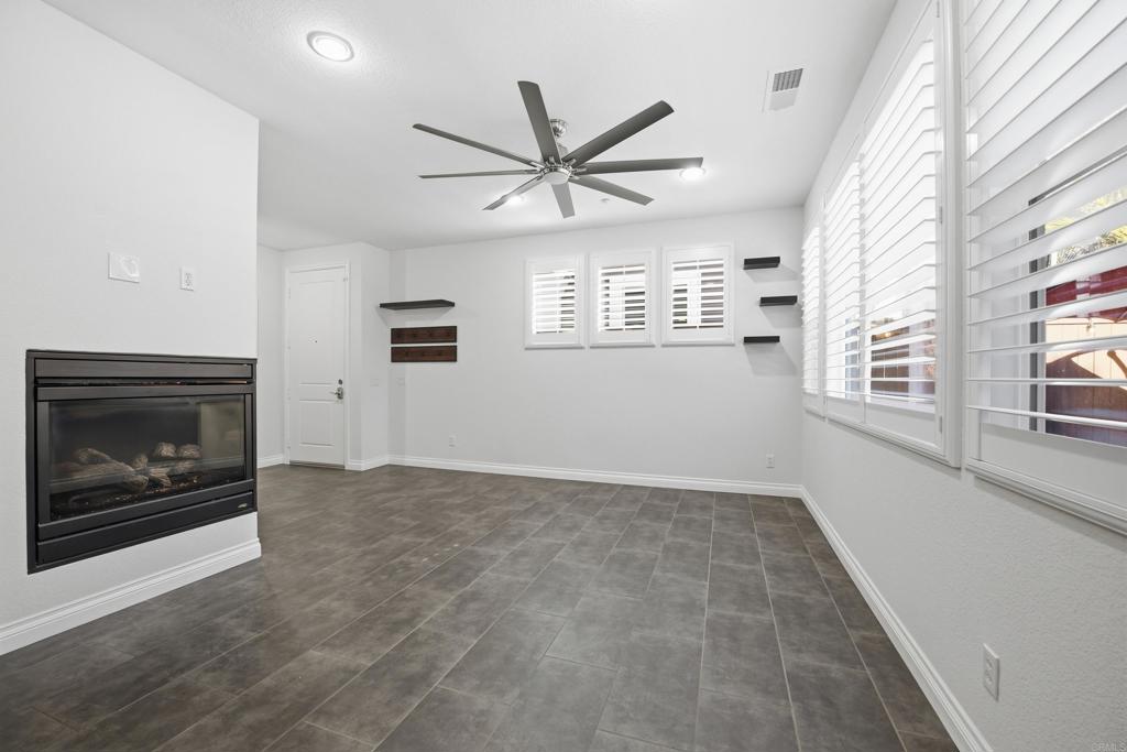 2284 Durango Way, Unit 200 San Marcos, CA 92078 - Photo 4 of 39 a view of an empty room with a fireplace and a window