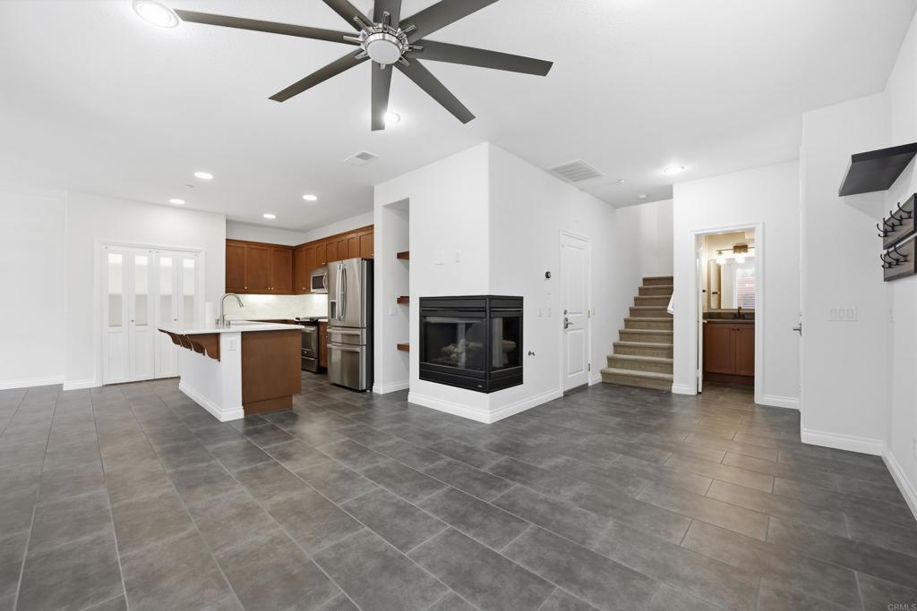 2284 Durango Way, Unit 200 San Marcos, CA 92078 - Photo 5 of 39 a view of a kitchen with a stove cabinets and a ceiling fan