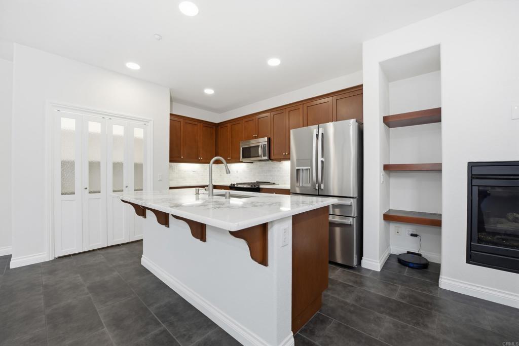 2284 Durango Way, Unit 200 San Marcos, CA 92078 - Photo 6 of 39 a kitchen with stainless steel appliances granite countertop a refrigerator and a sink
