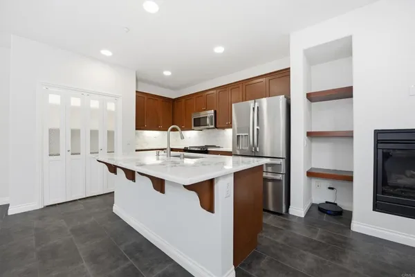 a kitchen with stainless steel appliances granite countertop a sink stove and cabinets