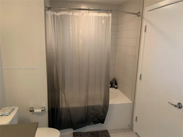 a bathroom with a shower and a toilet