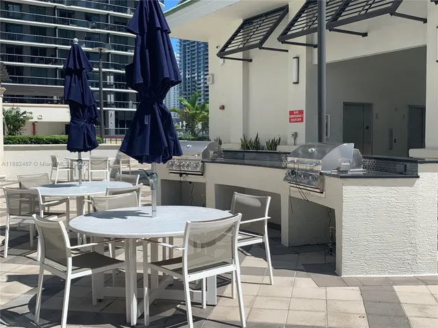 a dining area with a table and chairs