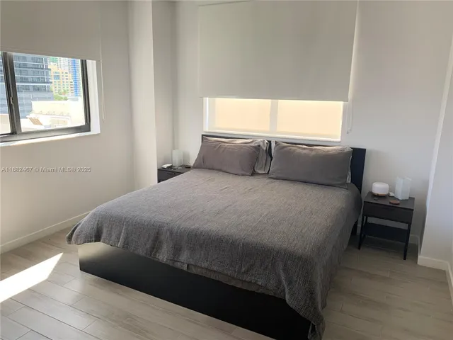 a bed sitting in a bedroom next to a window