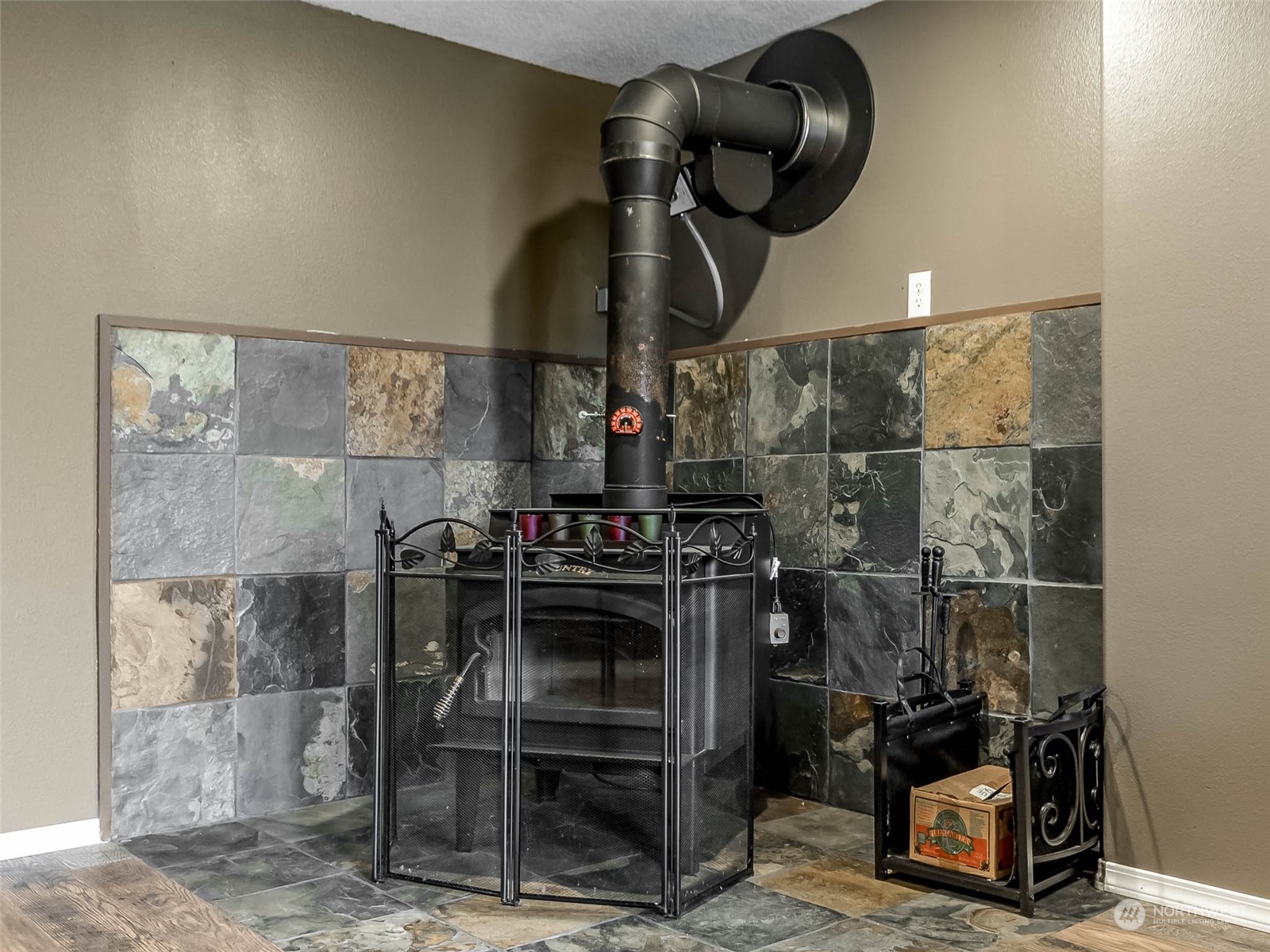 6 White Road Raymond, WA 98577 - Photo 13 of 40 a close view of water heater and wooden cabinets