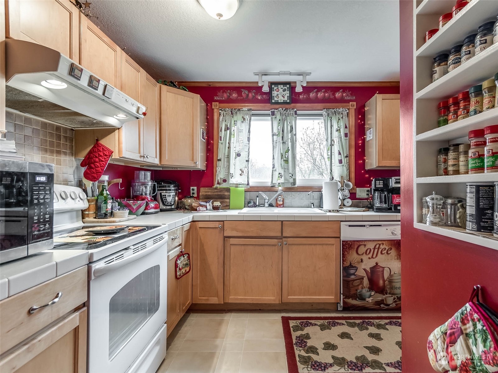 6 White Road Raymond, WA 98577 - Photo 17 of 40 a kitchen with stainless steel appliances granite countertop a stove a sink and a microwave