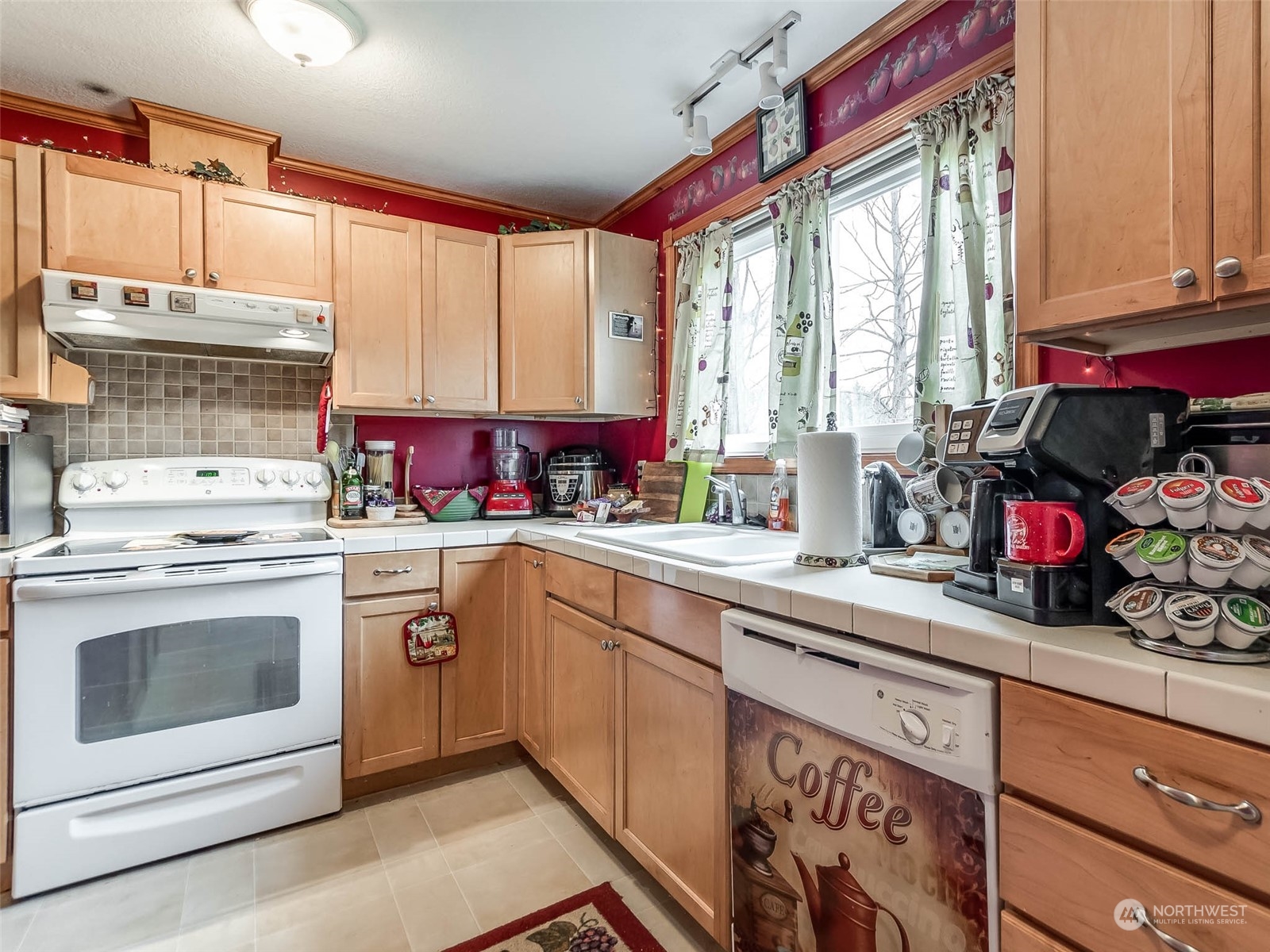 6 White Road Raymond, WA 98577 - Photo 19 of 40 a kitchen with a stove a sink and a microwave