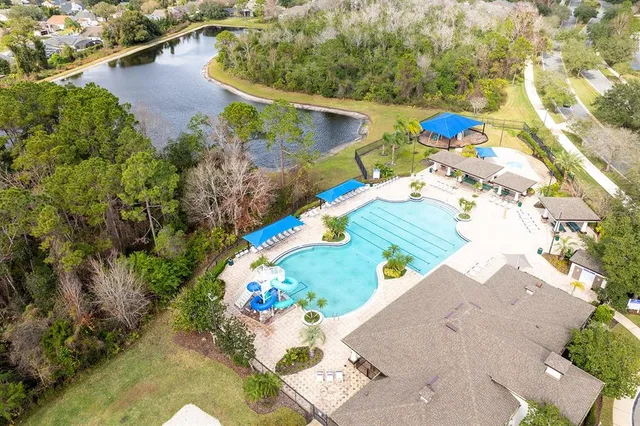 an aerial view of a house with a yard and lake view