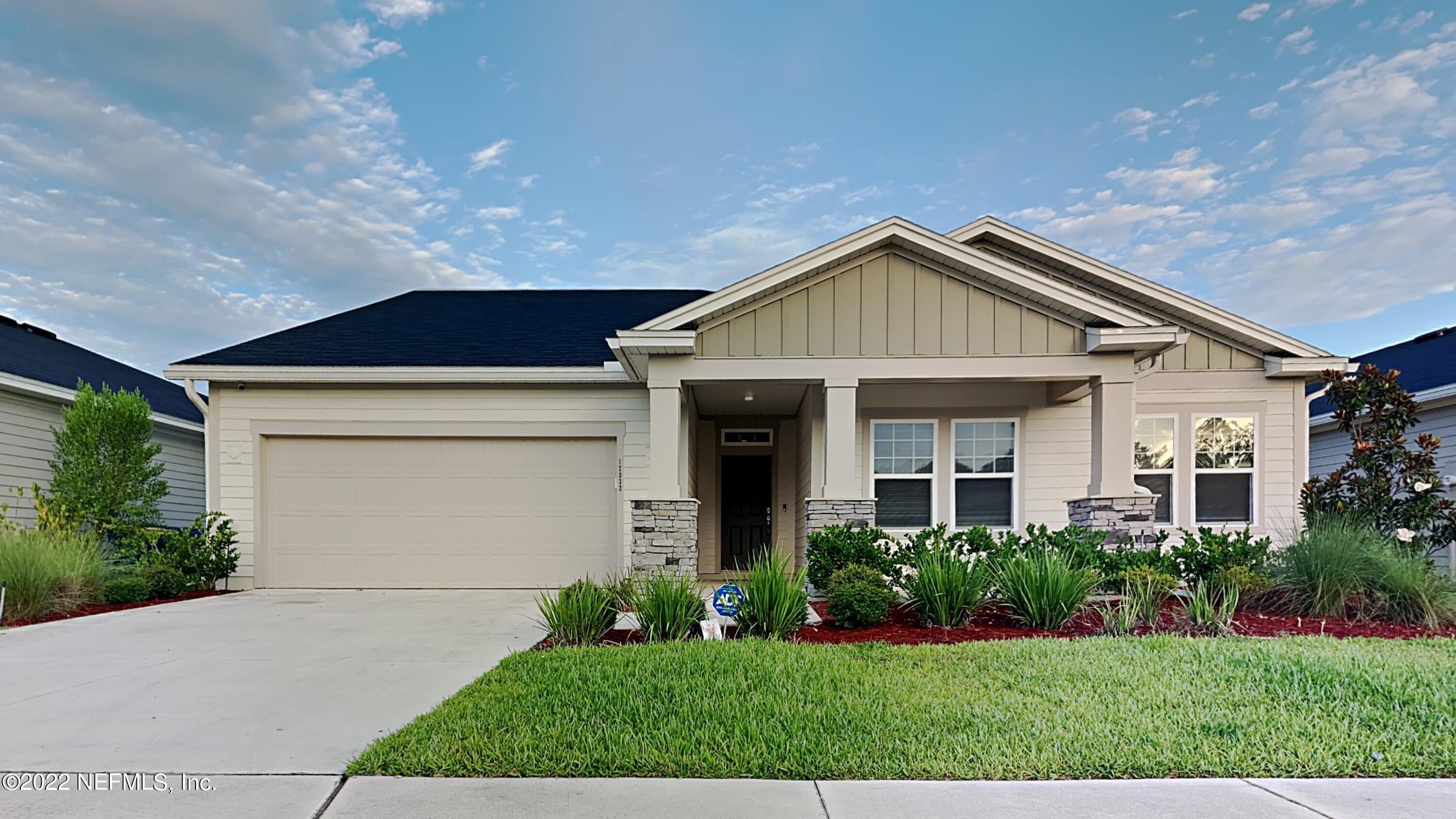 a front view of a house with a yard and garage