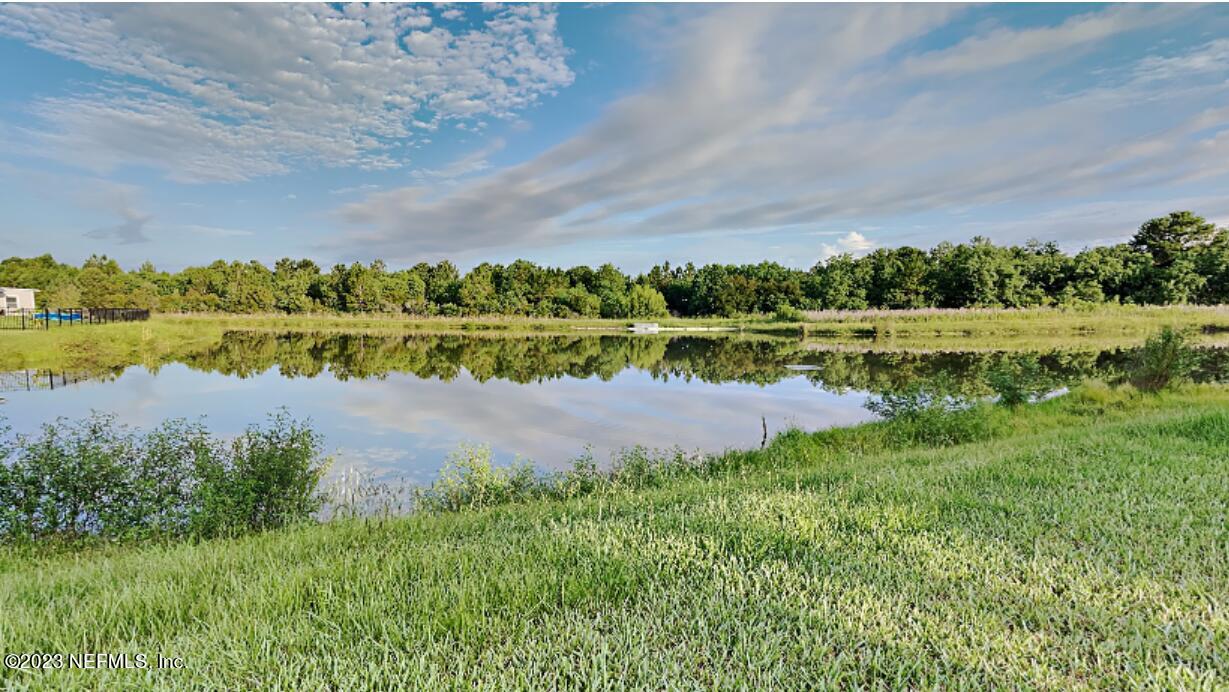 12032 Bridgehampton Road Jacksonville, FL 32218 - Photo 12 of 13 a view of lake with green field