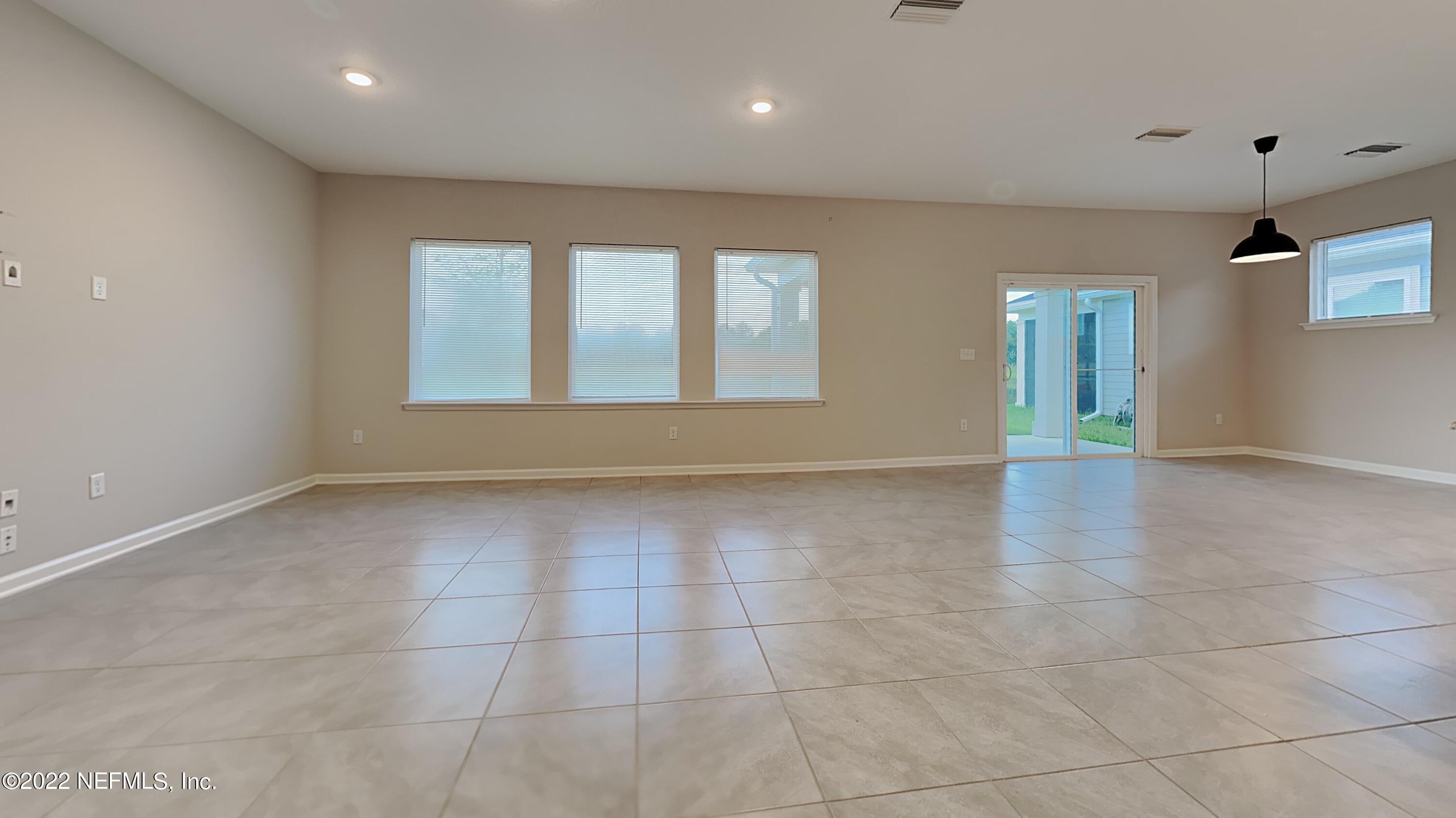 12032 Bridgehampton Road Jacksonville, FL 32218 - Photo 4 of 13 a view of an empty room with glass door